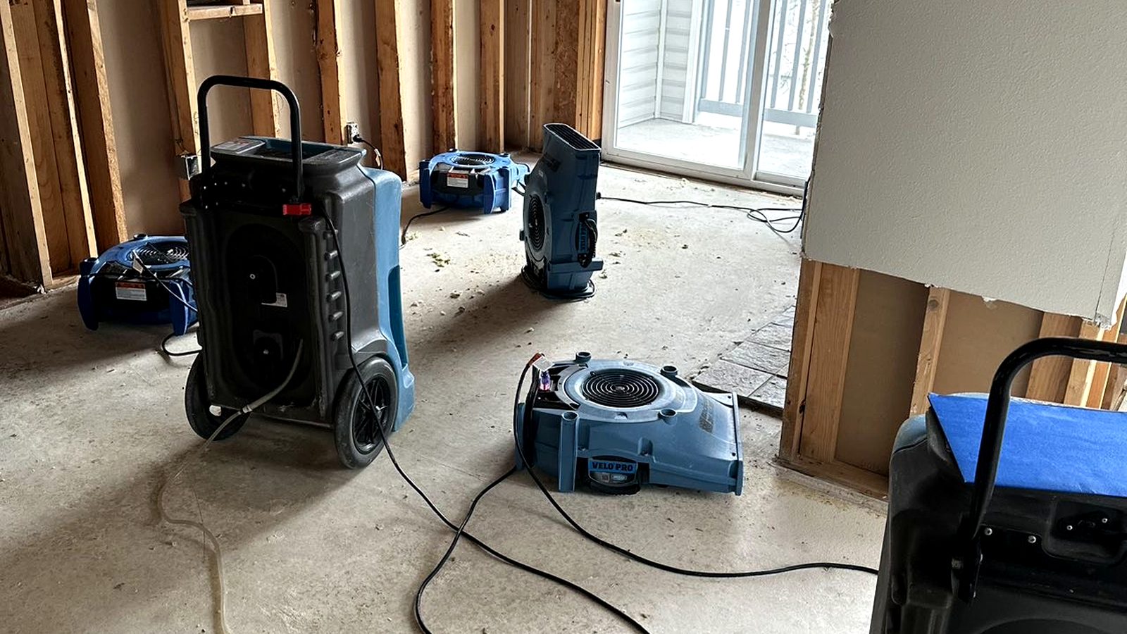 Commercial air movers and a dehumidifier deployed for structural drying after a water loss.